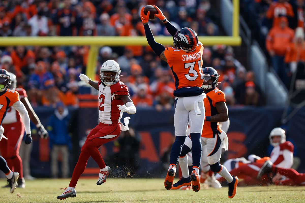 Justin Simmons jumps off the ground as he catches the ball